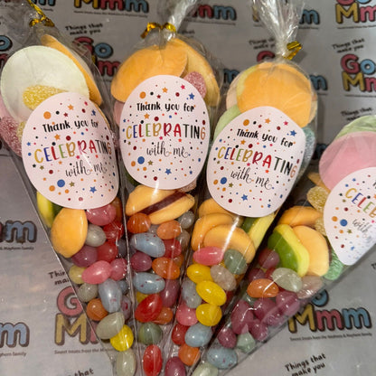 Bouquets of colorful candies in clear packaging with decorative labels on a branded background.