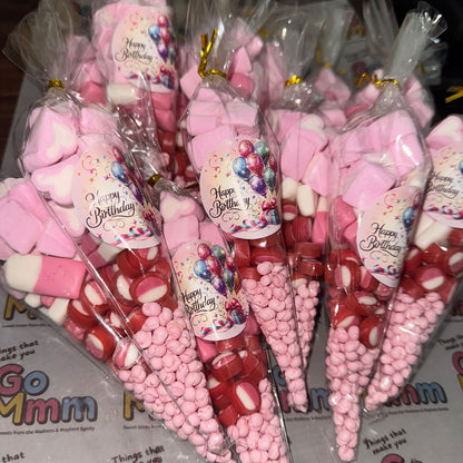 Cones filled with pink and red candies on a Go Mmm branded surface.